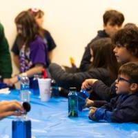 kids participating in the make a sea bottle event at sibs and kids weekend